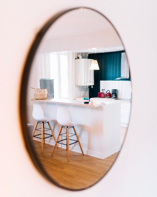 A mirror with a reflection of a cosy interior